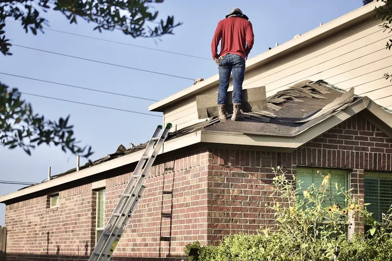 Professional roofer working on a residential roof in Moosic